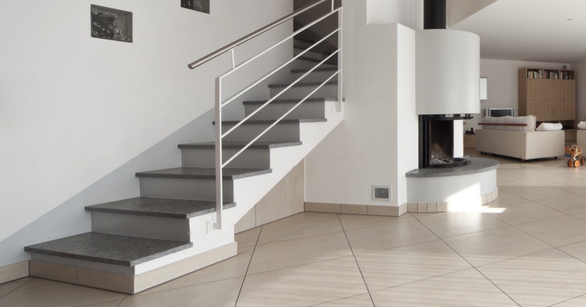 Staircase with tiled treads and stainless steel railing